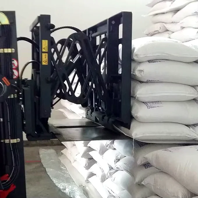 Forklift push-pull attachment pulling bagged animal feed on a paper slip sheet with no pallet